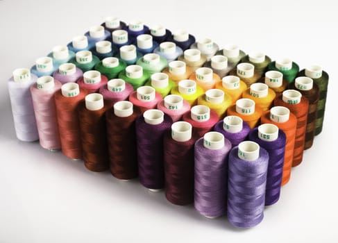 Sewing threads as a multicolored background closeup