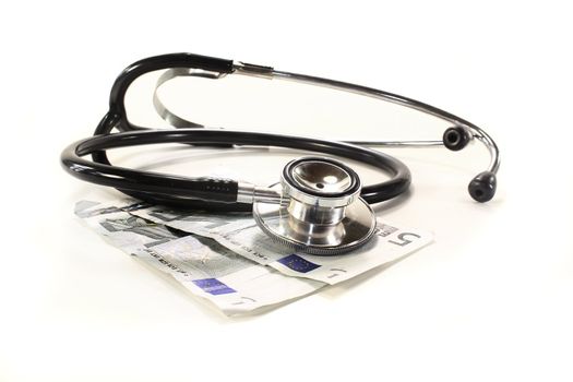 Stethoscope and money on a light background