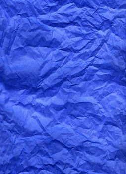 Wrinkled blue silk paper texture background.