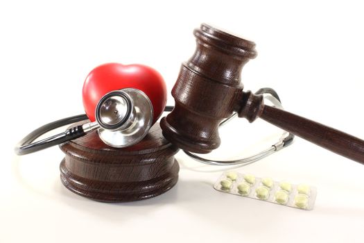 Medical law - with judges gavel, stethoscope and tablets