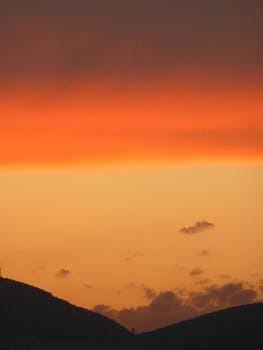 beautiful orange sunset over distant mountains