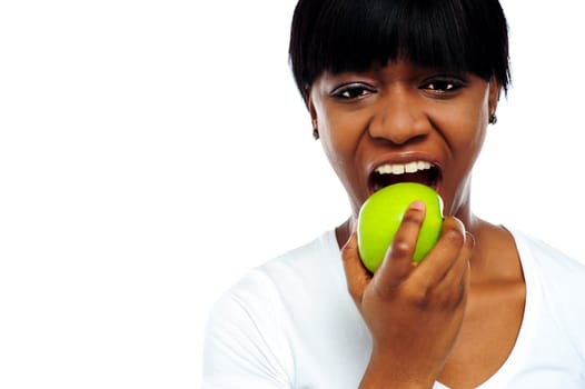 Close up shot pretty lady eating green apple in front of camera