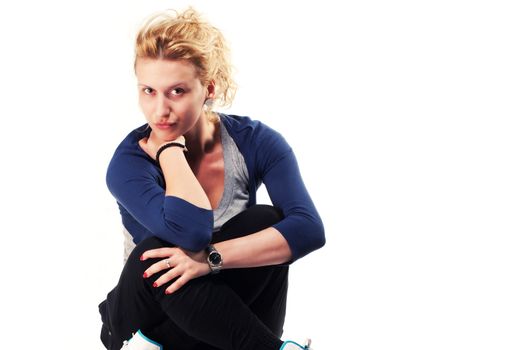 Girl sitting on ground in studio isolated on white