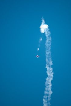 Massive air trail from a plane doing aerobatics