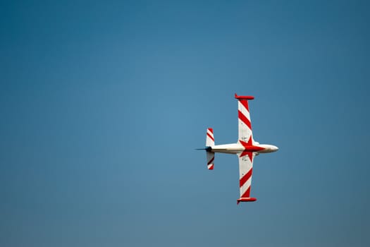 Head on shot of a plane flip on blue skies