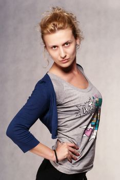 Young model posing in studio in loose clothes