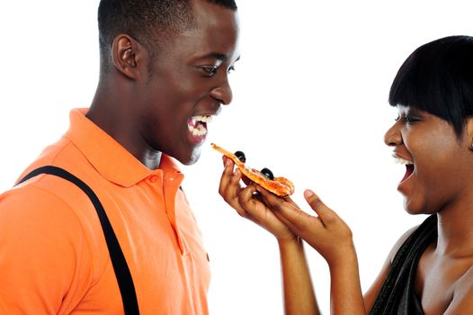 Gorgeous girl offering pizza to handsome guy