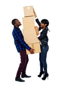A young couple holds boxes in studio isolated over white background