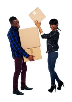 Man holding pile of cardboard boxes as woman places them one at a time