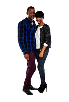 Portrait of a romantic young couple standing together over white background