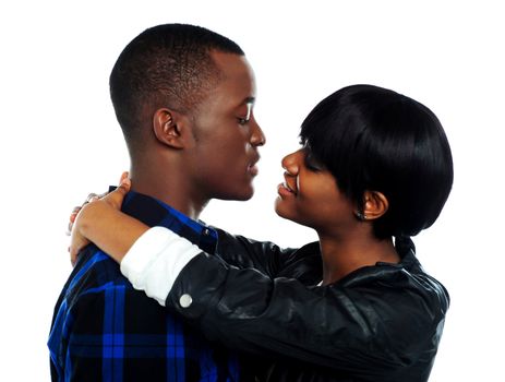 Young affectionate african couple hugging. Isolated over white background