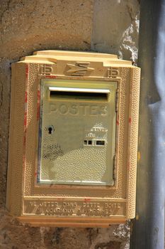 Old yellow mailbox in France, postal service