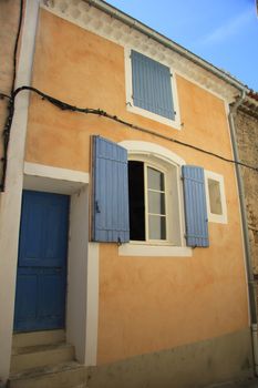 House in typical provencal style in France, windows with wooden shutters