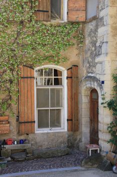 House in typical provencal style in France, windows with wooden shutters