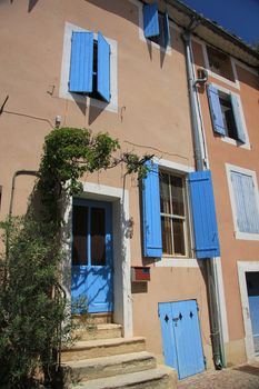 House in typical provencal style in France, windows with wooden shutters