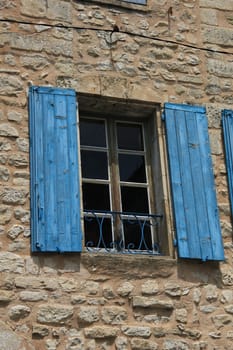 French style window with painted wooden shutters