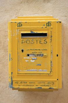 Old yellow mailbox in France, postal service