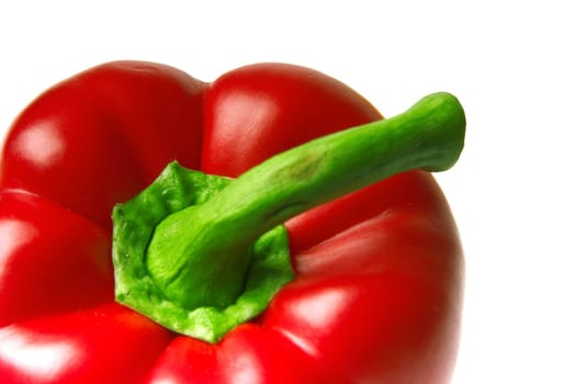 close-up of brightly red pepper with a green pod on a white background