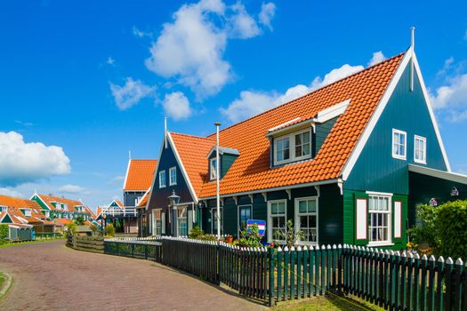 Typical dutch houses reflected in water on a sunny spring day.