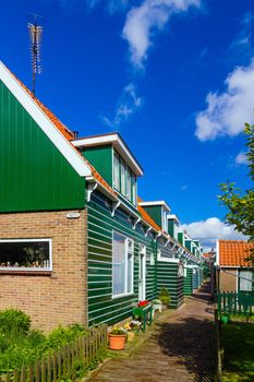 Typical dutch houses reflected in water on a sunny spring day. Vertical view