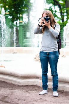 Cute girl taking photos during travel on holidays
