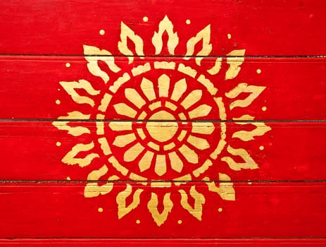 The Painting golden symbol of religion on wood in the  temple.The temple is open to the public and has beautiful murals on the walls.