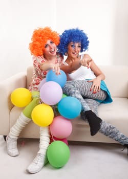 Girls clown with colourful balloons.