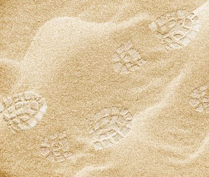 Shoeprints on the beach sand.