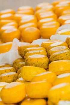 Variety of Dutch cheeses on a counter. Vertical view