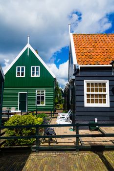 Typical dutch houses reflected in water on a sunny spring day. Vertical view