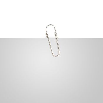 Gray note paper with paper clip on white background.