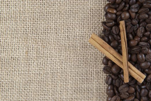 Background of burlap and coffee beans with a copy space.