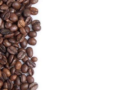 Coffee beans on a white background with a copy space.