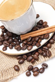 Still life about coffee with a delicious  espresso and some coffee beans and cinnamon.