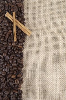 Background of burlap and coffee beans with a copy space.