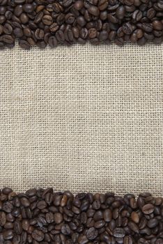Background of burlap and coffee beans with a copy space.