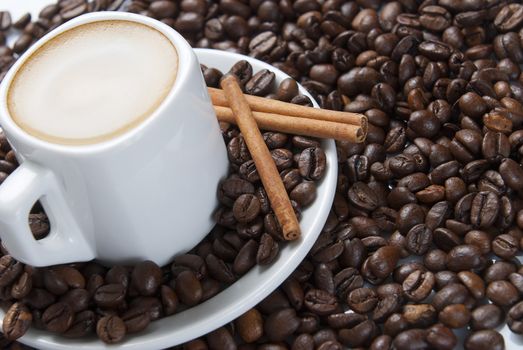 Still life about coffee with a delicious  espresso and some coffee beans and cinnamon.