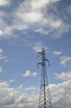 One Electricity Pylon with a Blue and Cloudy Sky