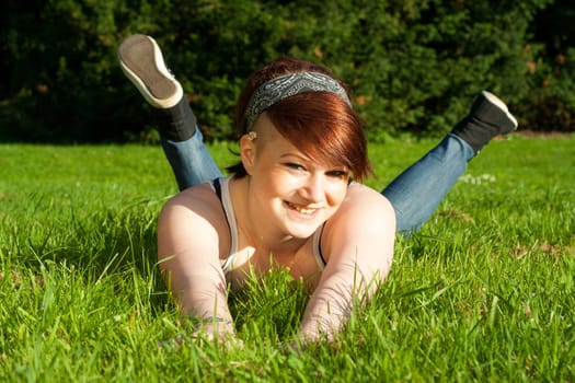 A beautiful young girl lying on the grass