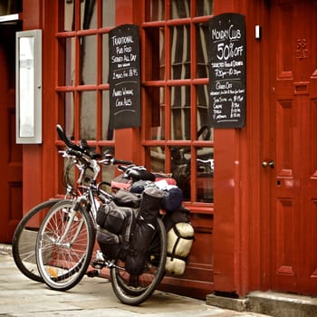 Bicycles on the Path Against a red pub