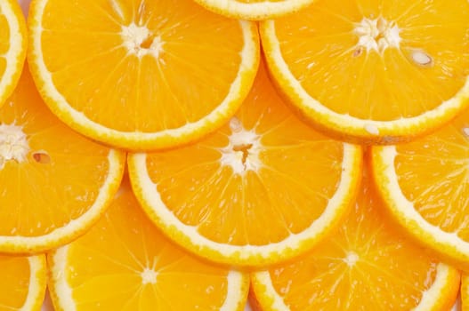Sliced juicy fresh delicious oranges background closeup
