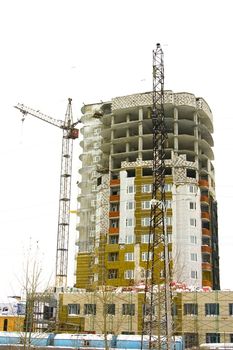 crane and unfinished multistory building on a white background
