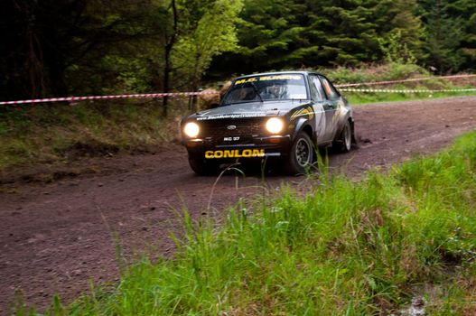 MALLOW, IRELAND - MAY 19: M. Conlon driving Ford Escort at the Jim Walsh Cork Forest Rally on May 19, 2012 in Mallow, Ireland. 4th round of the Valvoline National Forest Rally Championship.