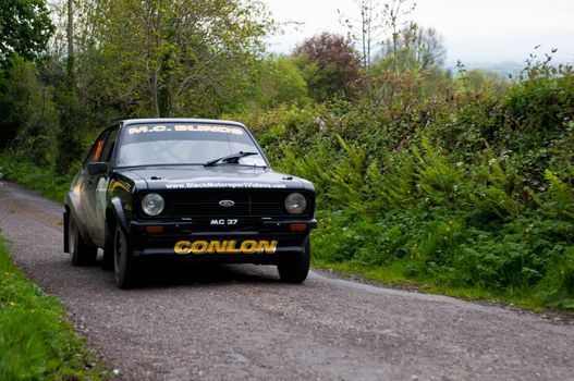 MALLOW, IRELAND - MAY 19: M. Conlon driving Ford Escort at the Jim Walsh Cork Forest Rally on May 19, 2012 in Mallow, Ireland. 4th round of the Valvoline National Forest Rally Championship.