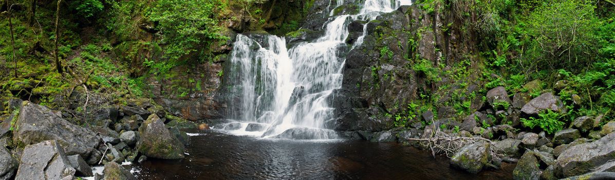stunning Torc waterfall in the Killarney National Park, Ireland (panoramic picture with 180 angle view)