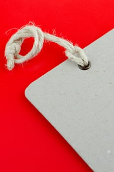 Closeup of blank product info label on red background.