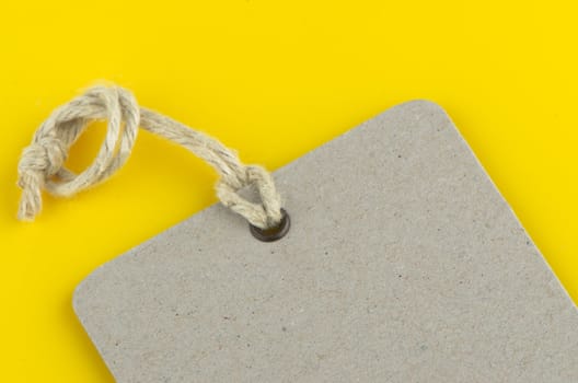Closeup of blank product info label on yellow background.