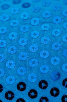 Bright blue paillette texture background.
