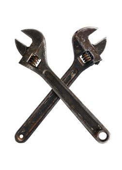 Two old rusty spanners crossing on white background