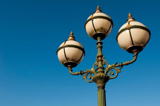 green vintage lamp posts against a blue sky background (Limerick, Ireland)